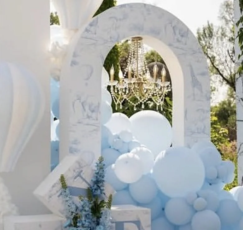 Toile-Bogen mit Kronleuchter, Heißluftballon und blauen Ballons im Freien